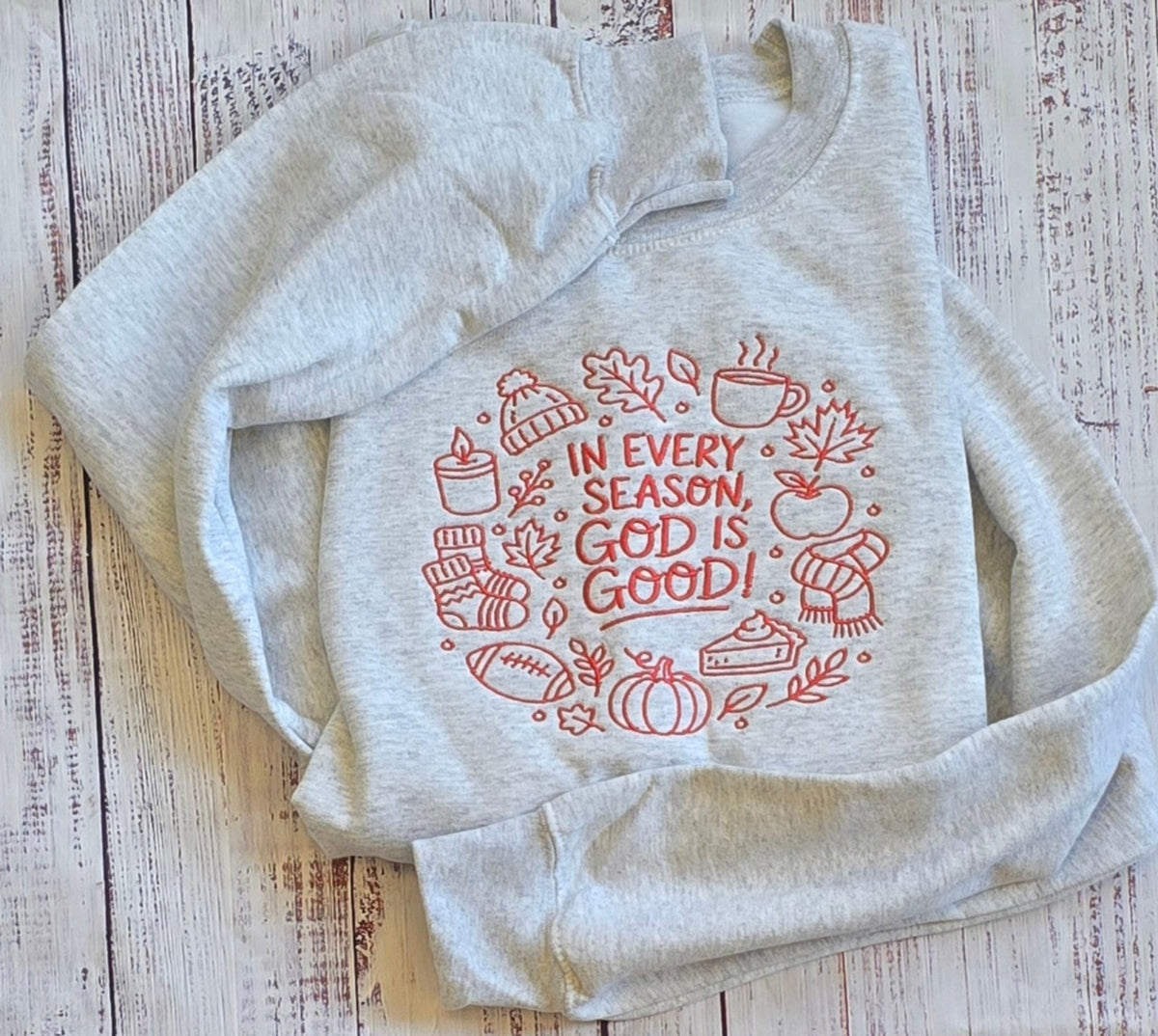 Close view of rust In Every Season God Is Good embroidery with pumpkin coffee and autumn icons