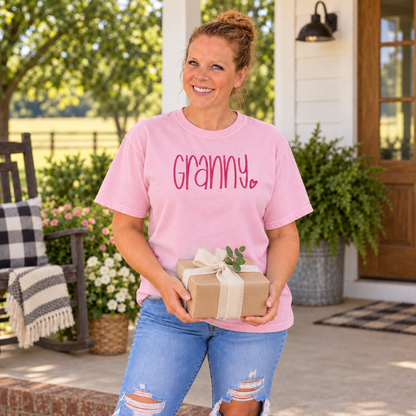 Samantha wearing a Blossom Comfort Colors tee with Granny embroidery while holding a gift