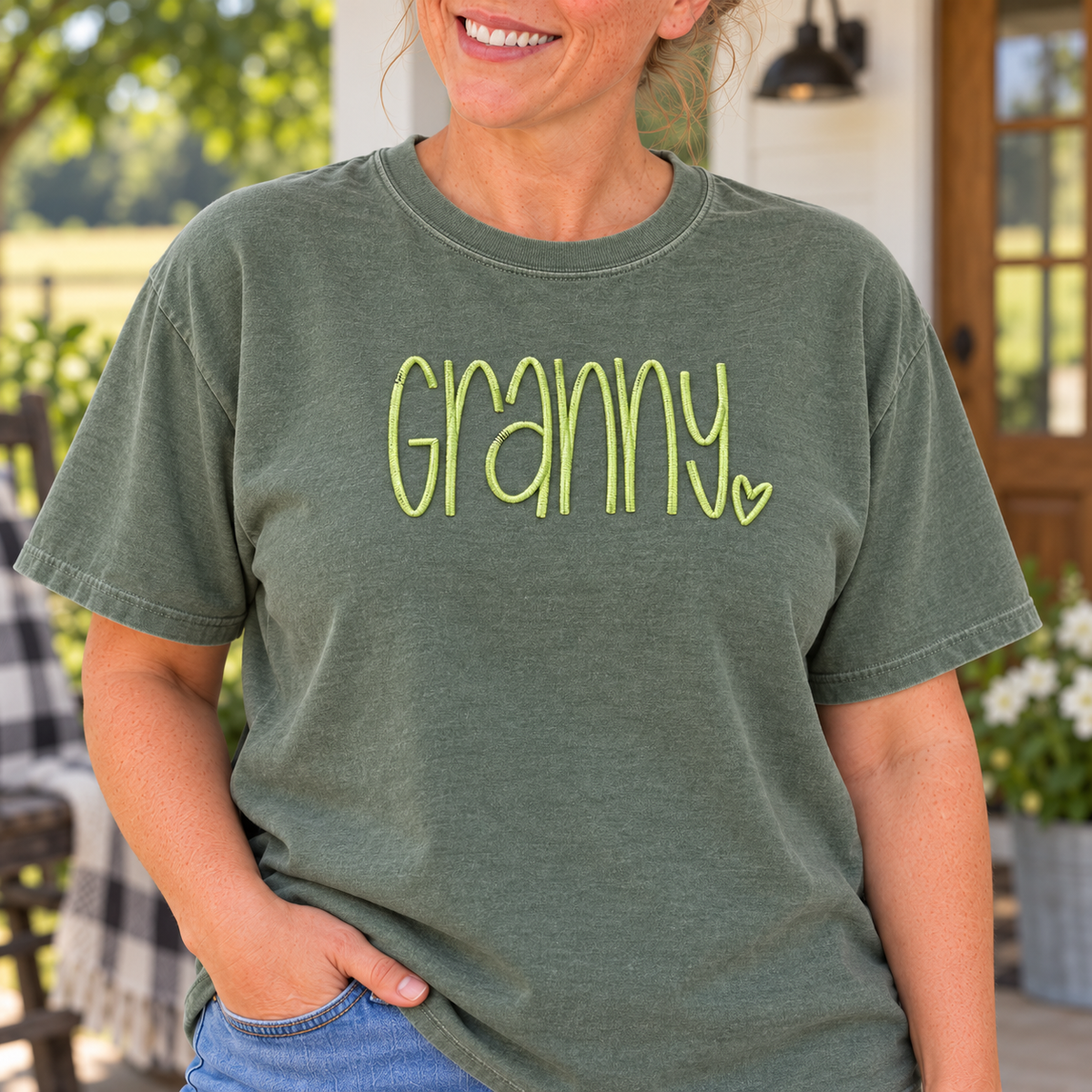 Close-up of raised light lime Granny embroidery on a Moss Comfort Colors tee