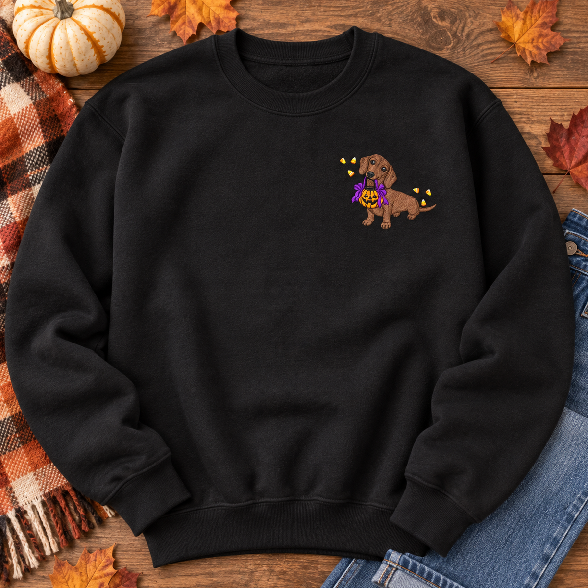 Black Halloween dachshund embroidered sweatshirt flat lay with autumn styling