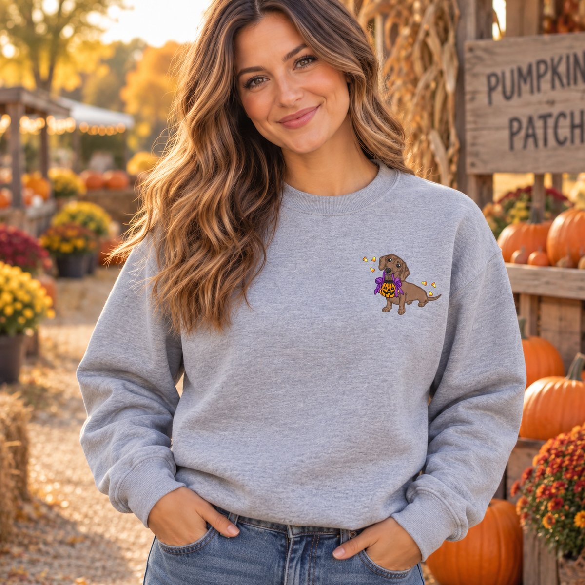 Woman wearing Sport Grey Halloween dachshund embroidered sweatshirt at a pumpkin patch