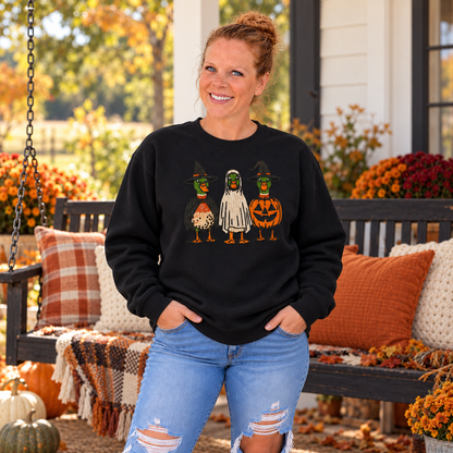 Woman wearing Black Halloween Duck embroidered sweatshirt by a fall porch swing