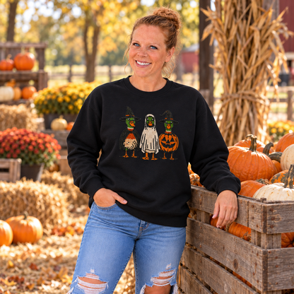 Woman wearing Black Halloween Duck embroidered sweatshirt beside pumpkins