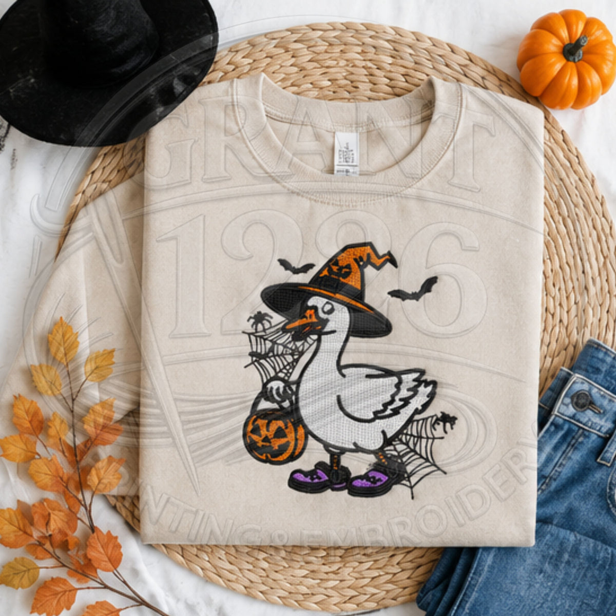 Sand Halloween goose embroidered crewneck with witch hat, jack-o-lantern bucket and spiderweb design