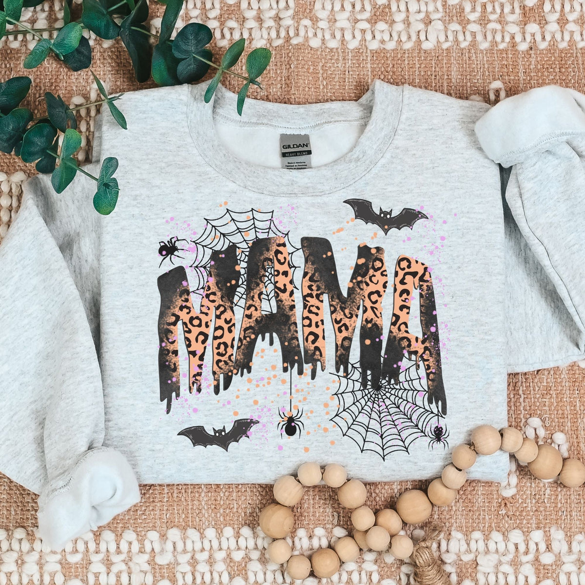 Ash Halloween mama sweatshirt flat lay with leopard MAMA graphic, bats and spiderwebs