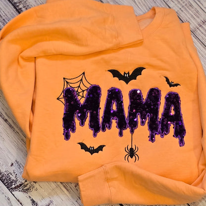 Cantaloupe Halloween MAMA sequin appliqué sweatshirt shown flat with embroidered bats, web, and hanging spider