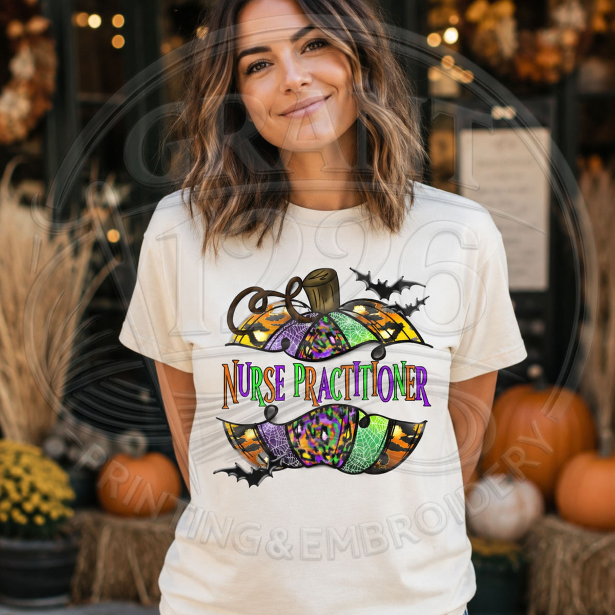 Ivory Comfort Colors short sleeve Nurse Practitioner Halloween shirt with colorful pumpkin and bats graphic, modeled outdoors.