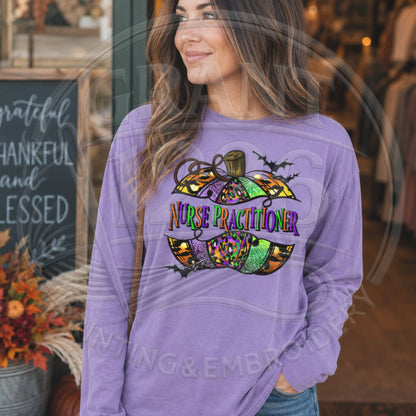 Violet Comfort Colors long sleeve Nurse Practitioner Halloween shirt with colorful pumpkin and bats graphic, modeled outdoors.