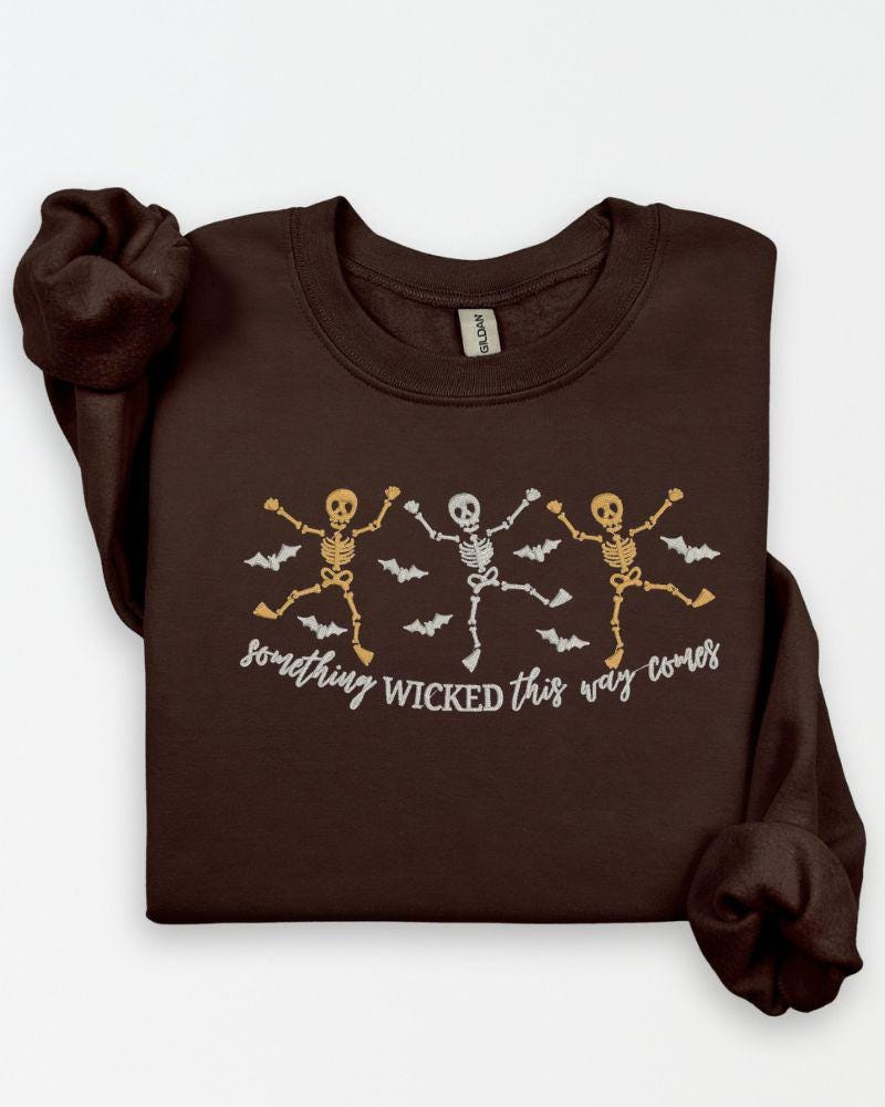 Halloween skeleton embroidered sweatshirt with dancing skeletons, bats and Something Wicked wording