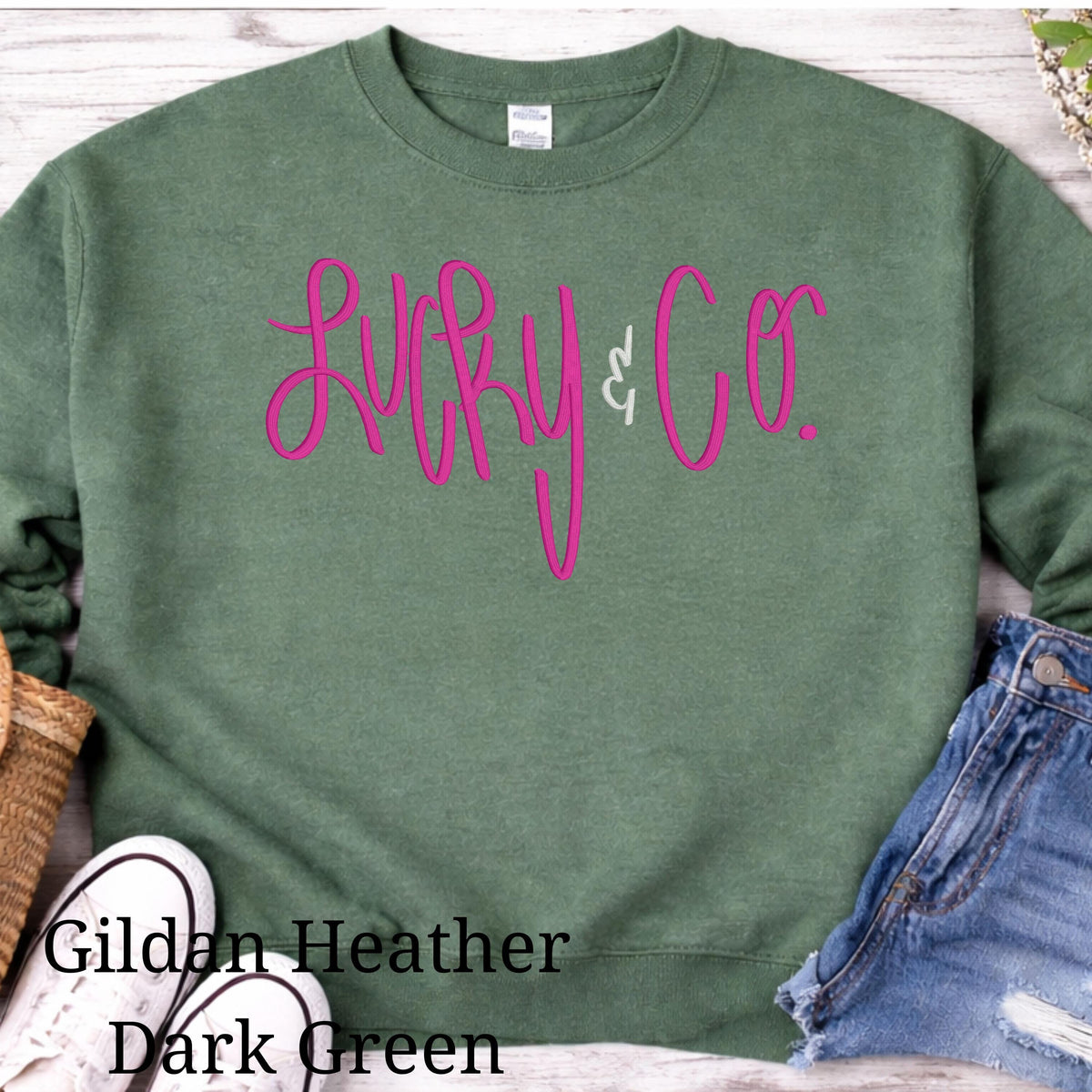 Heathered Dark Green St. Patrick’s Day crewneck with embroidered shamrock design
