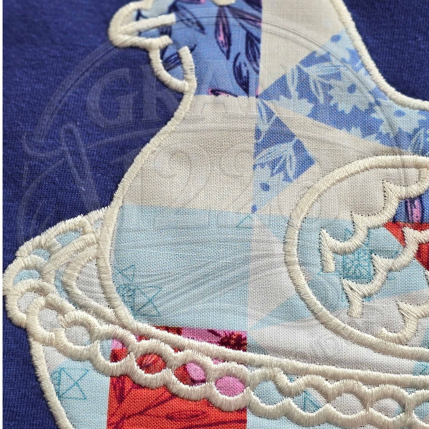 Closeup embroidery detail of patchwork chicken applique design