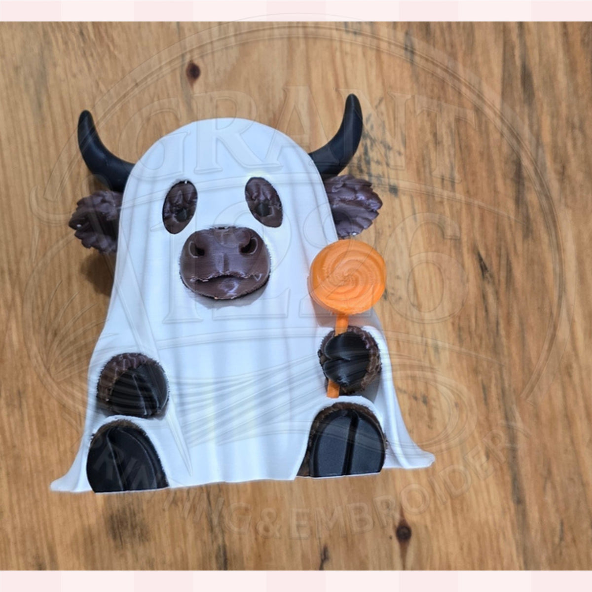 3D printed Highland cow ghost figurine displayed on a wooden surface