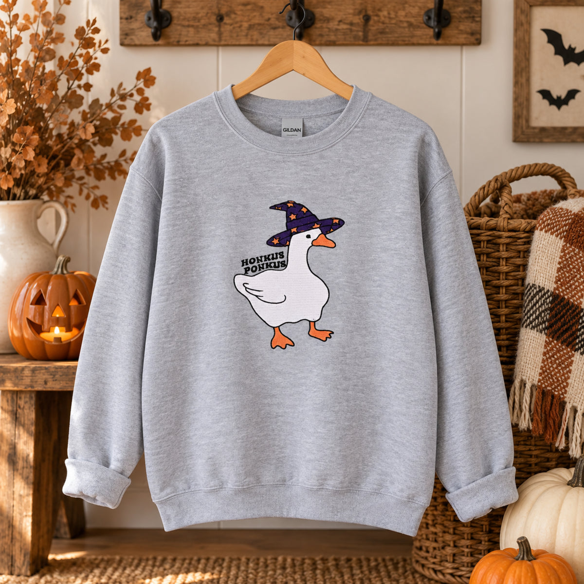 Honkus Ponkus witch goose embroidered crewneck in a cozy fall entryway