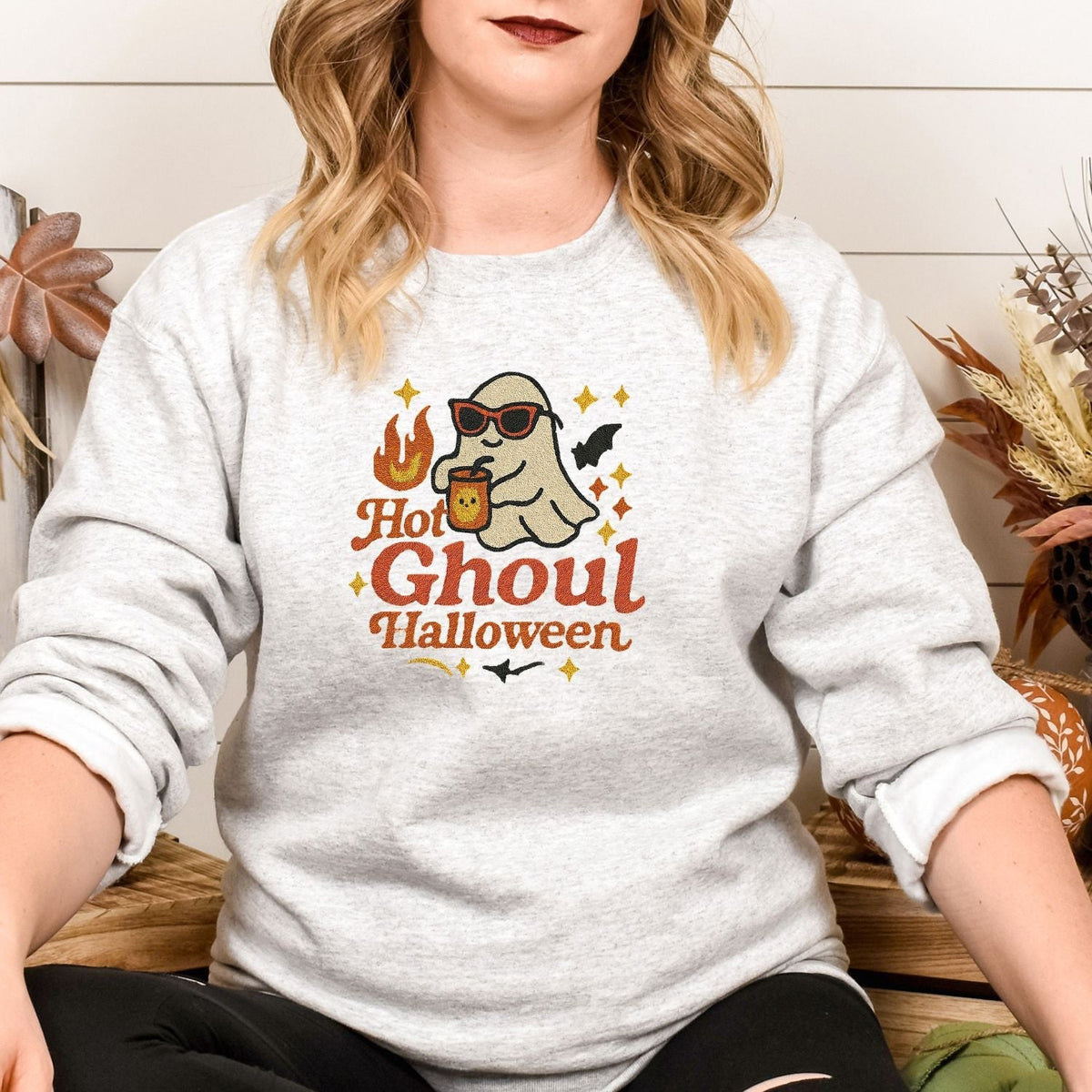 Woman wearing an Ash Hot Ghoul embroidered Halloween sweatshirt