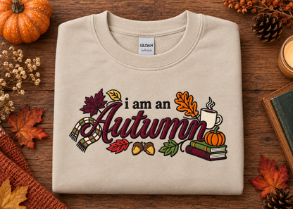Sand embroidered I Am an Autumn Gildan Softstyle sweatshirt flat lay with fall accessories