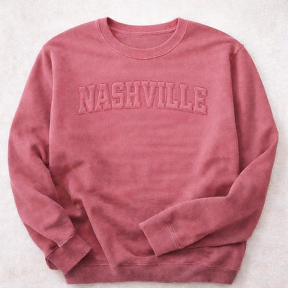 Flat lay of custom raggy applique sweatshirt styled casually
