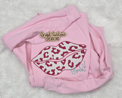 Close-up of embroidered Valentine design on crewneck sweatshirt