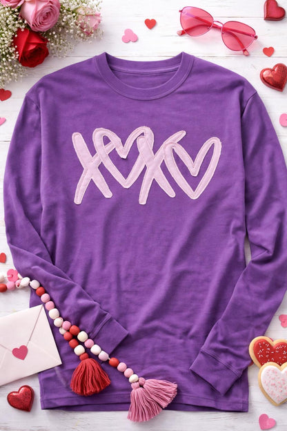 Close-up of machine embroidered raggy applique XOXO lettering grape