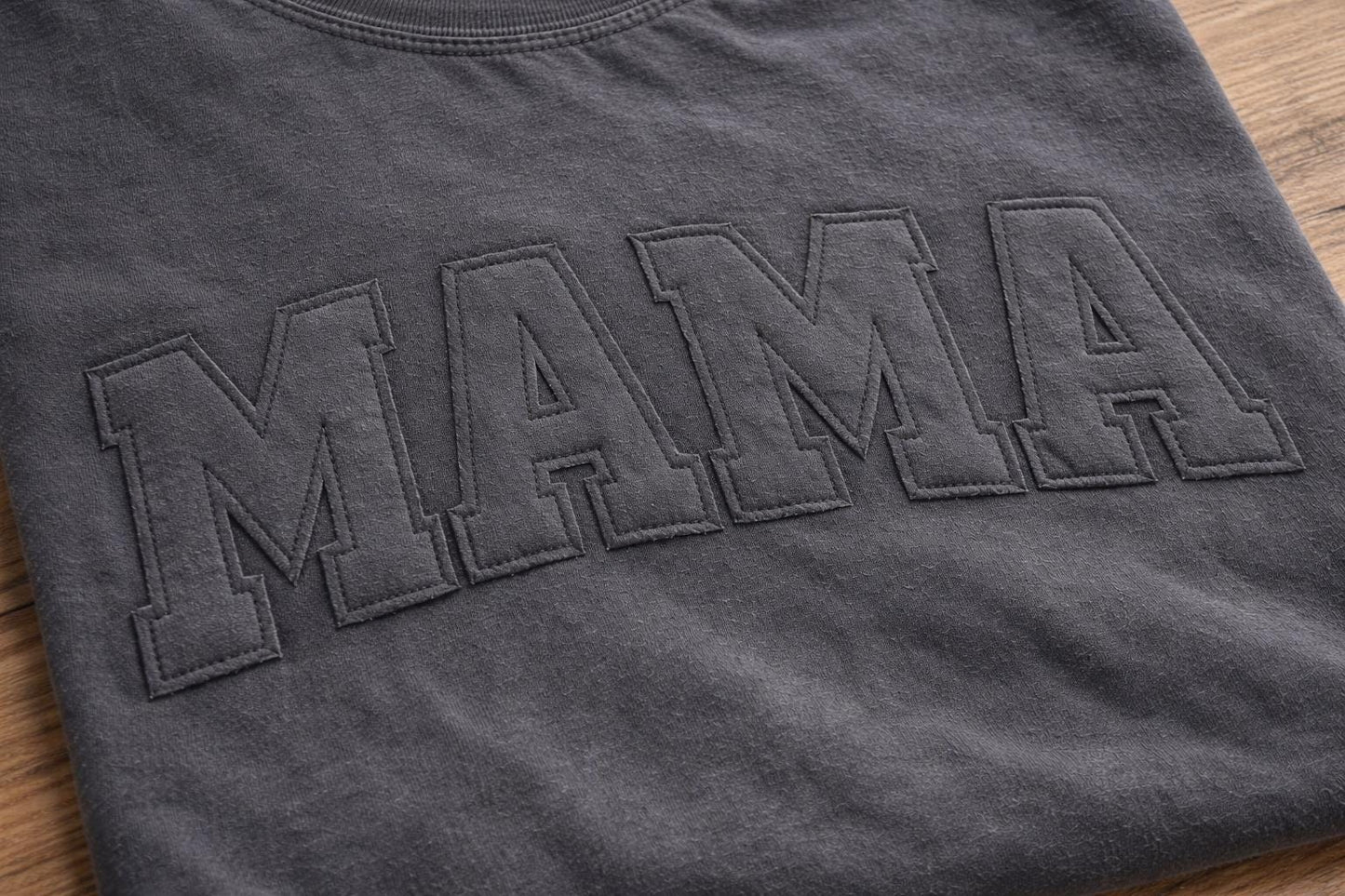 Close-up of stitched applique lettering on custom Comfort Colors shirt