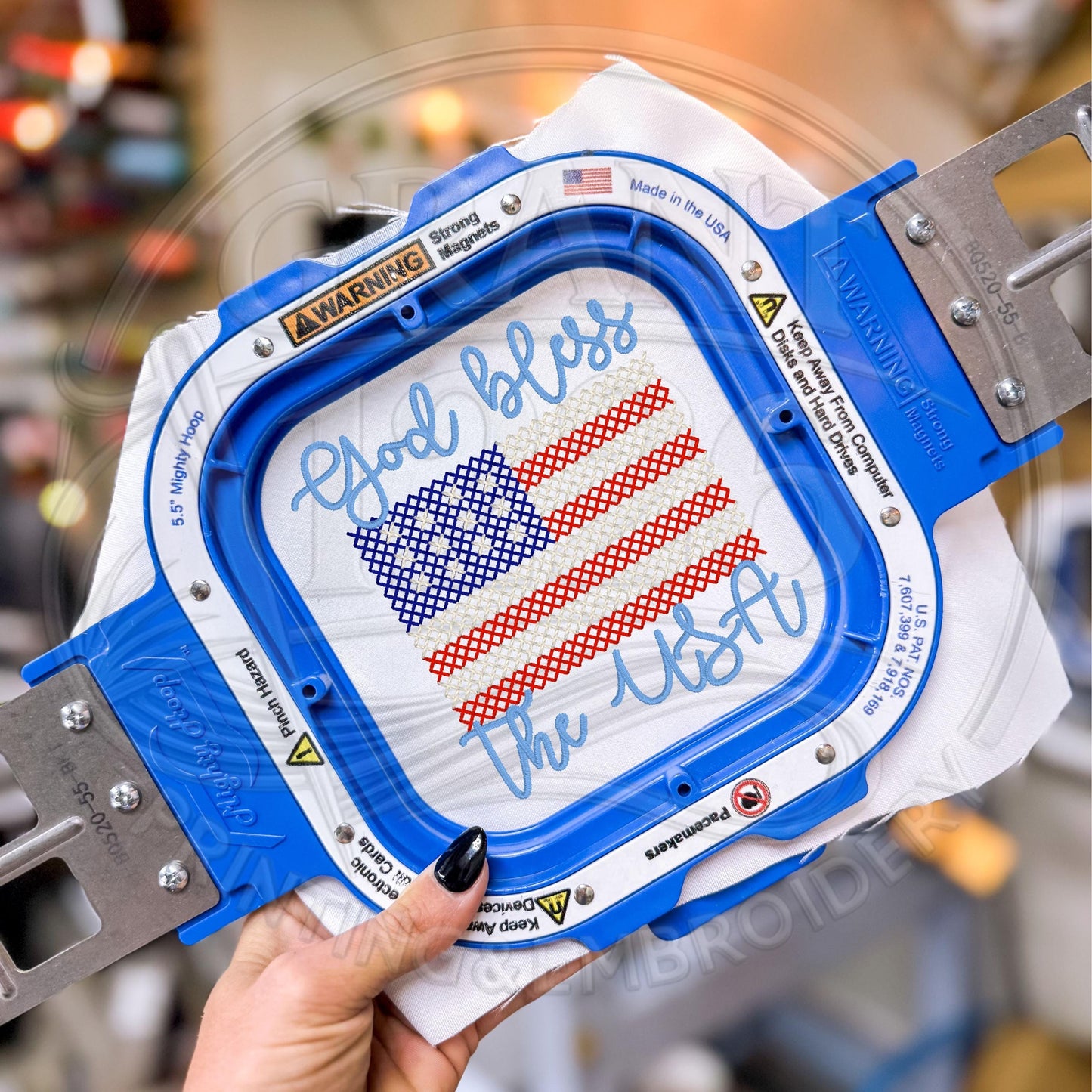 Embroidery machine stitching God Bless the USA patriotic flag design