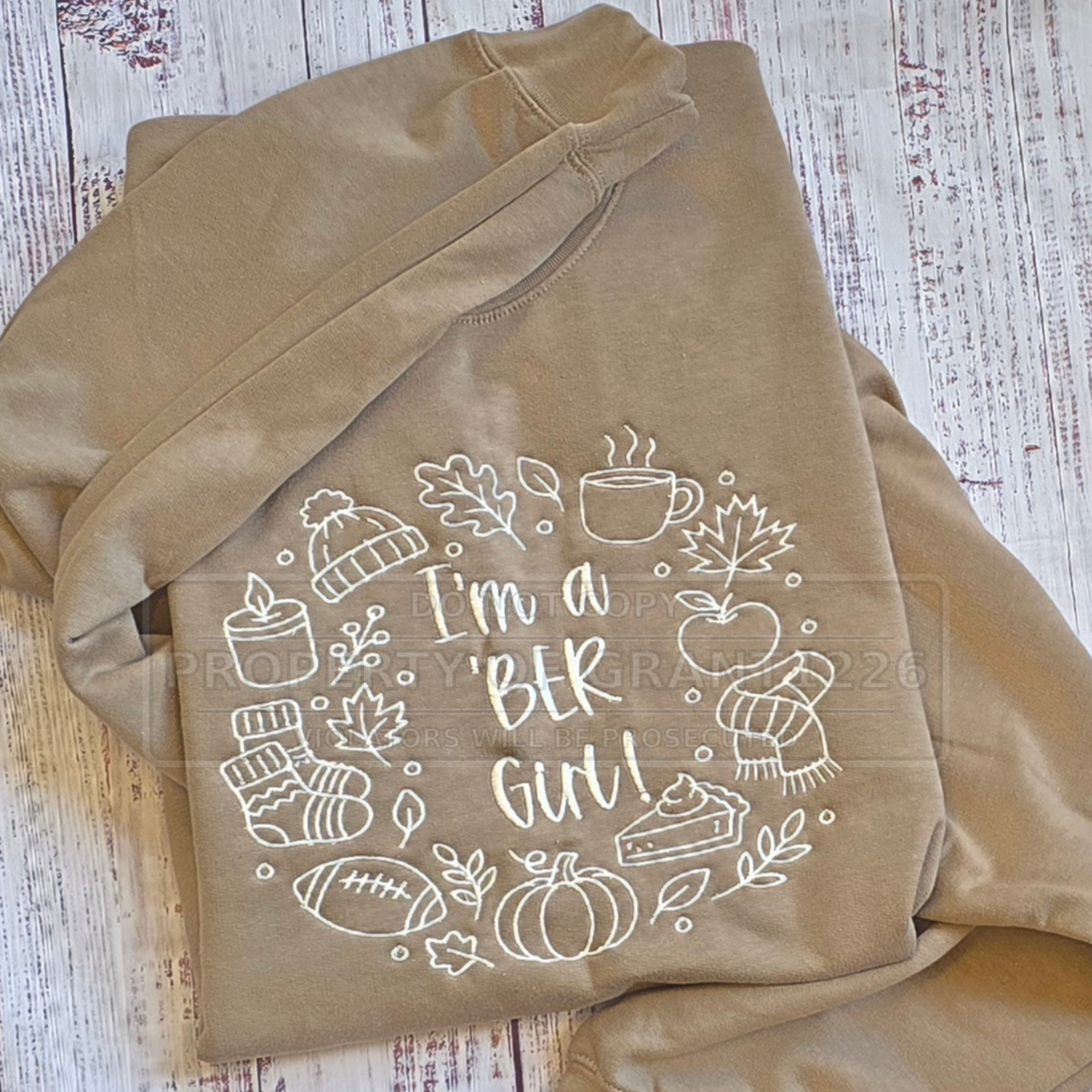 Sand embroidered sweatshirt reading I’m a BER Girl with cozy fall icons in cream thread