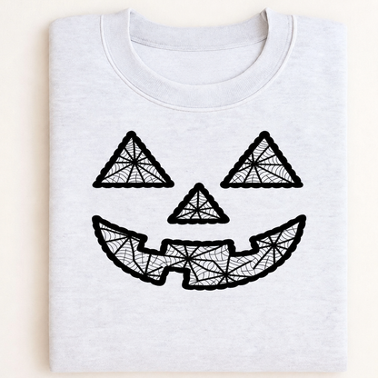 Folded light gray sweatshirt mockup with black geometric jack-o-lantern embroidery centered on the chest