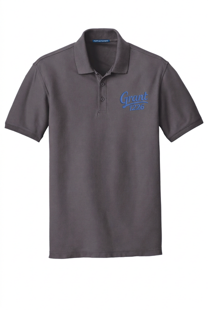 Graphite Port Authority K100 polo mockup with blue Grant 1226 left-chest embroidery