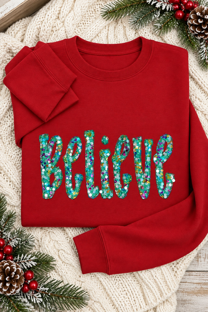 Mockup of red Believe sequin appliqué crewneck sweatshirt in a holiday flat lay