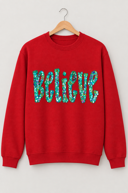 Studio hanging mockup of a red Believe sequin appliqué crewneck sweatshirt