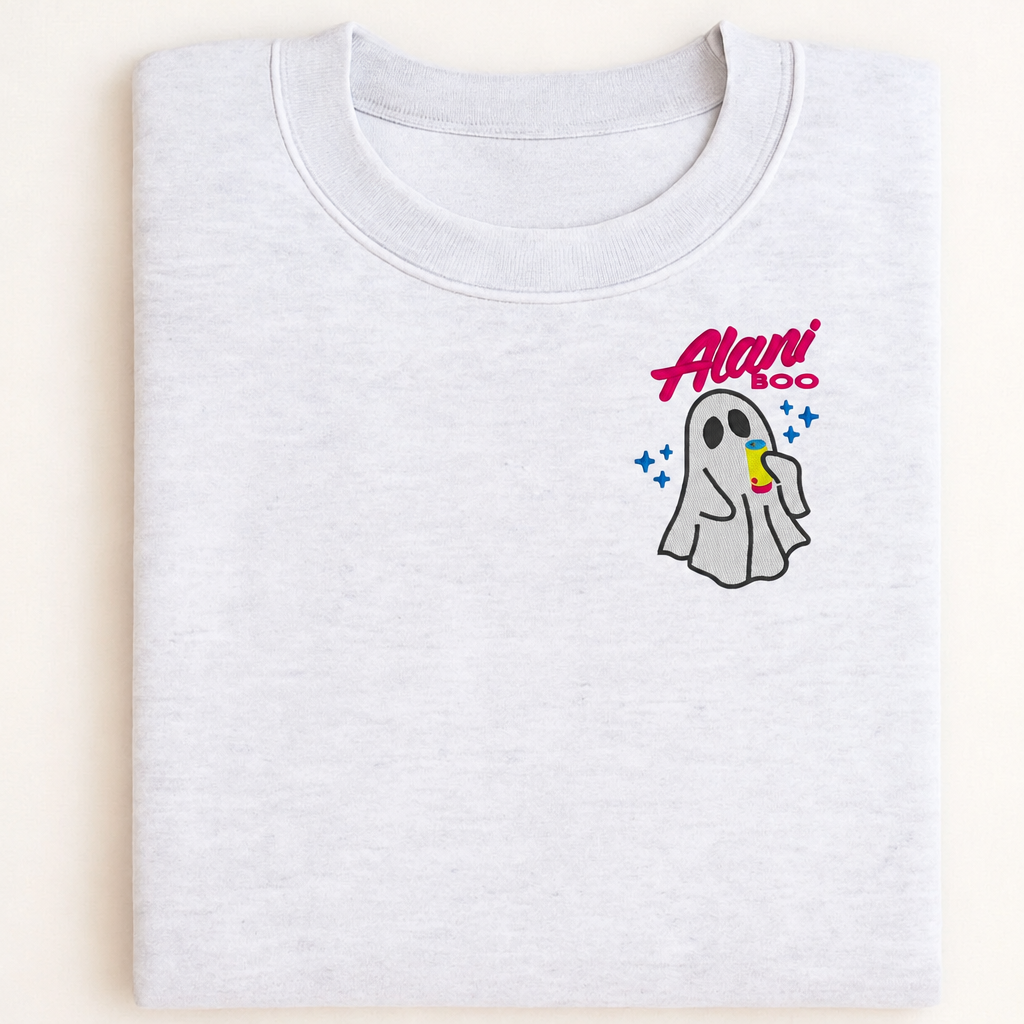 Mockup of an Ash Cozy Ghost sweatshirt with left-chest ghost and drink embroidery, folded flat lay