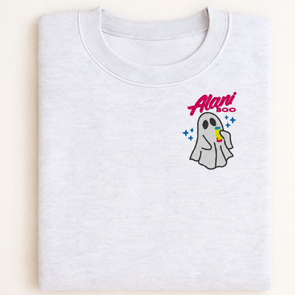 Mockup of an Ash Cozy Ghost sweatshirt with left-chest ghost and drink embroidery, folded flat lay