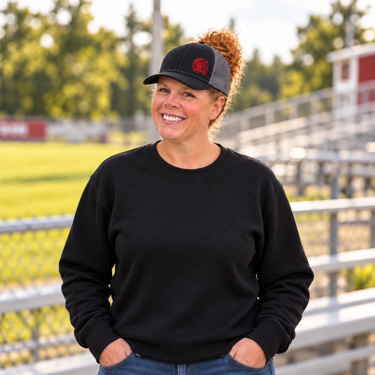 Samantha wearing a black and charcoal Richardson 112 hat with a red embroidered Indians mascot