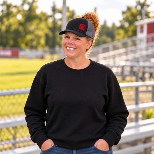 Samantha wearing a black and charcoal Richardson 112 hat with a red embroidered Indians mascot