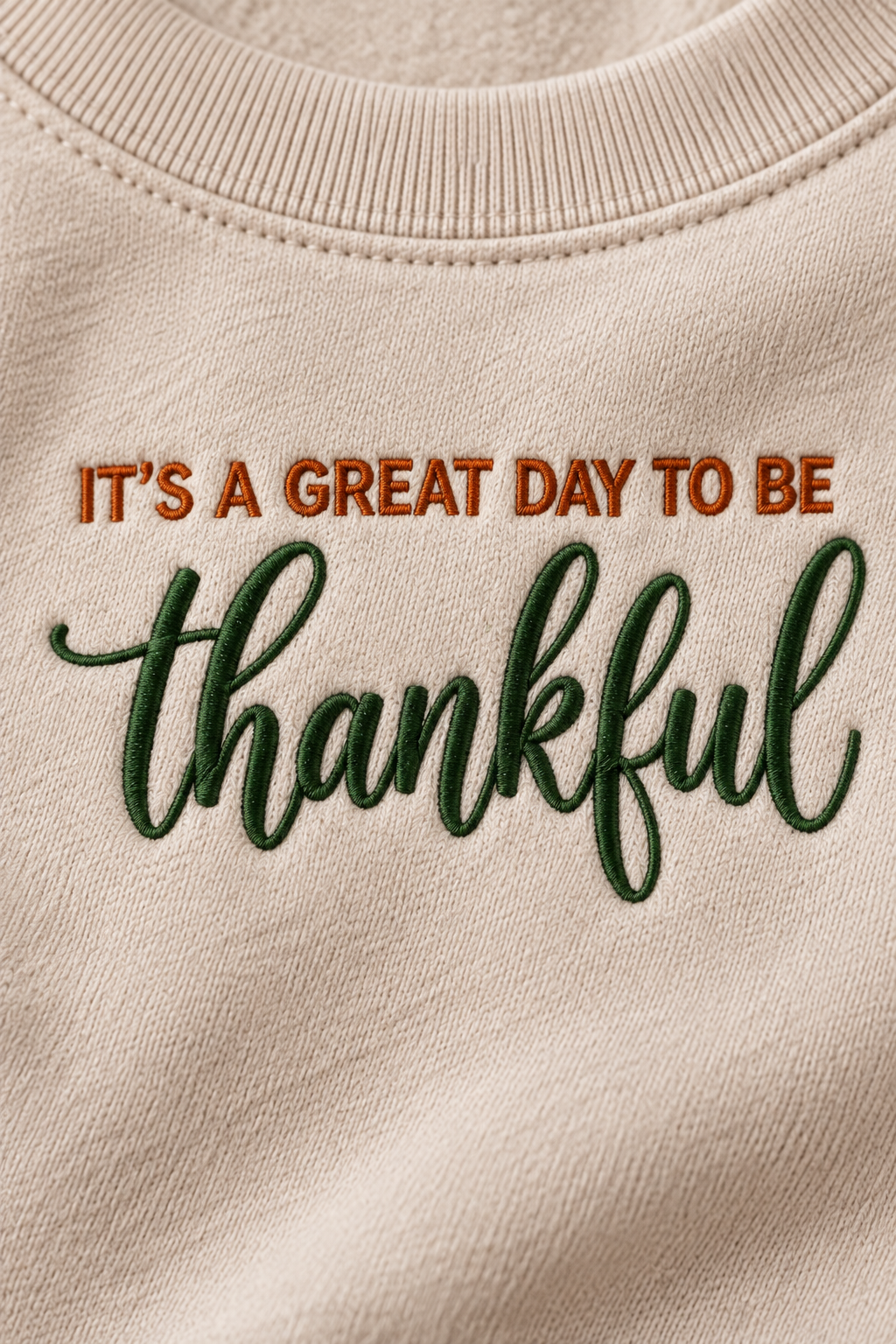 Close-up of burnt orange and forest green thankful embroidery