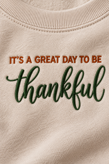 Close-up of burnt orange and forest green thankful embroidery