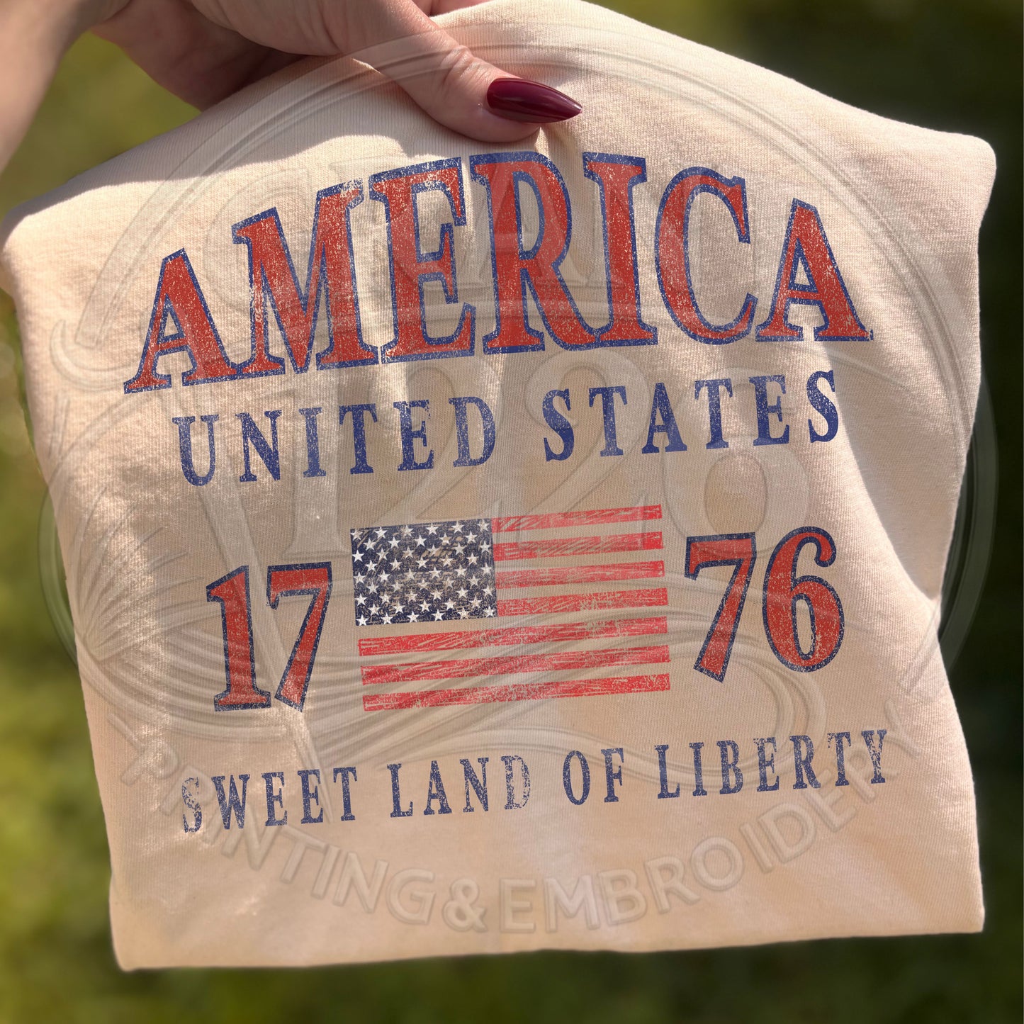 Close up of ivory America United States patriotic shirt with retro American flag design