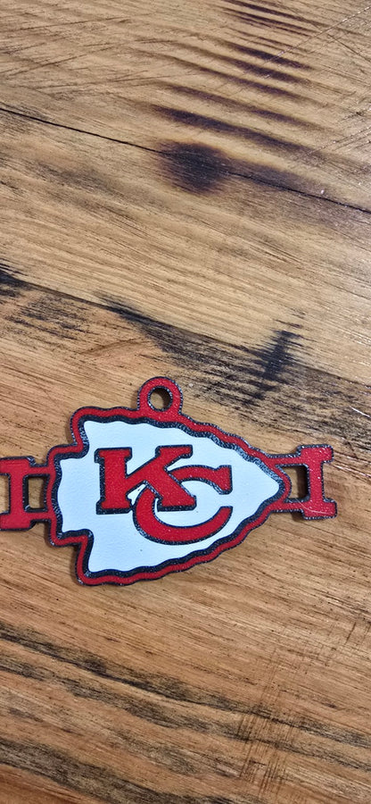 Close-up of a red, white, and black Kansas City football arrowhead hair tie holder
