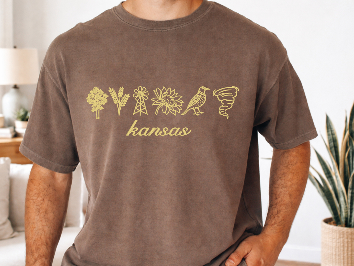 Brown Kansas embroidered Comfort Colors shirt modeled indoors