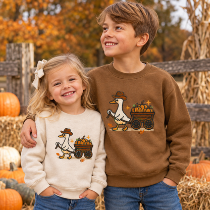 Toddler and youth siblings wearing Natural and Coyote Brown pumpkin wagon goose embroidered sweatshirts