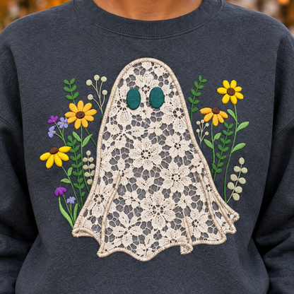 Close-up of ivory floral lace ghost appliqué, satin stitched edge and colorful wildflower embroidery