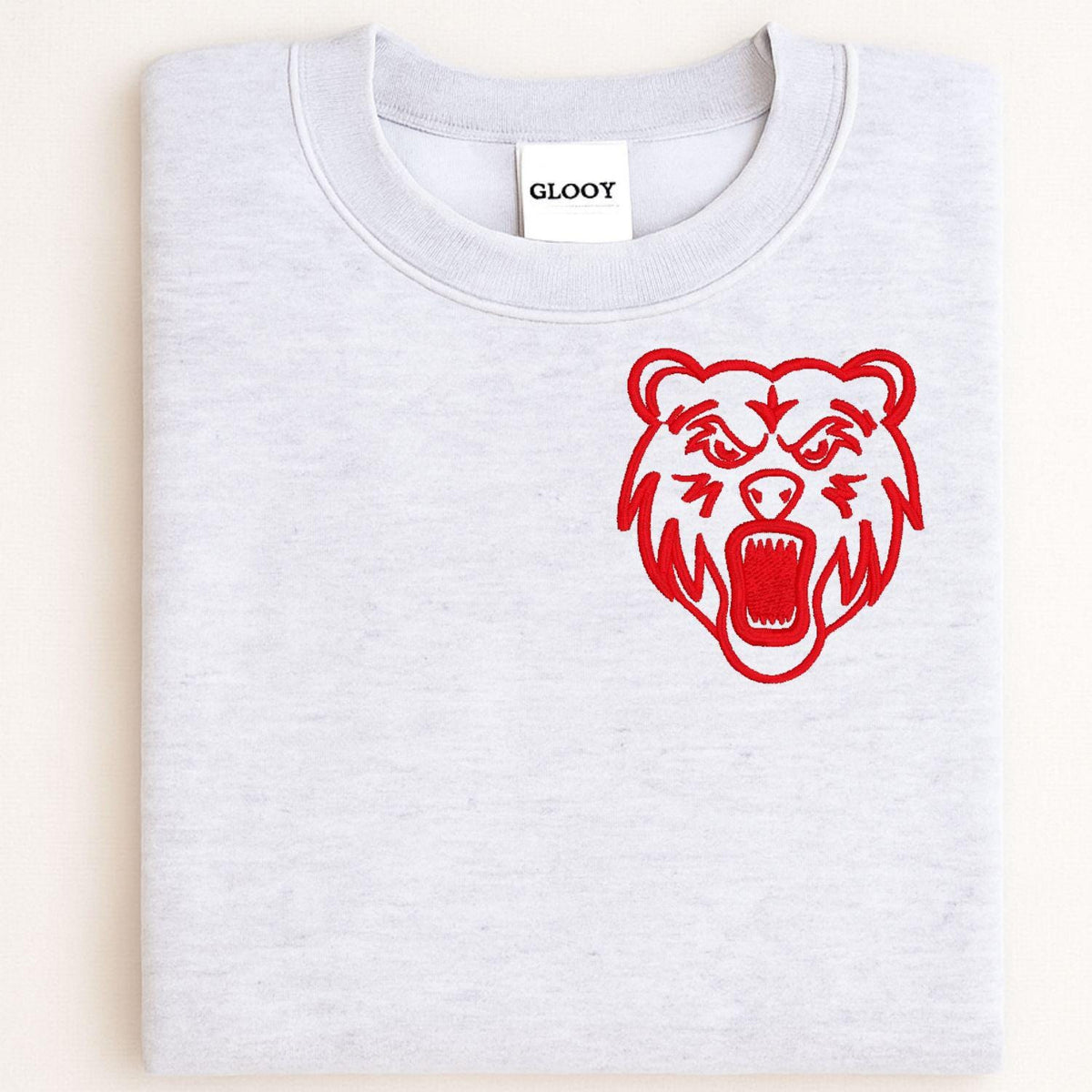 Sport gray sweatshirt with red left-chest bear mascot embroidery folded flat