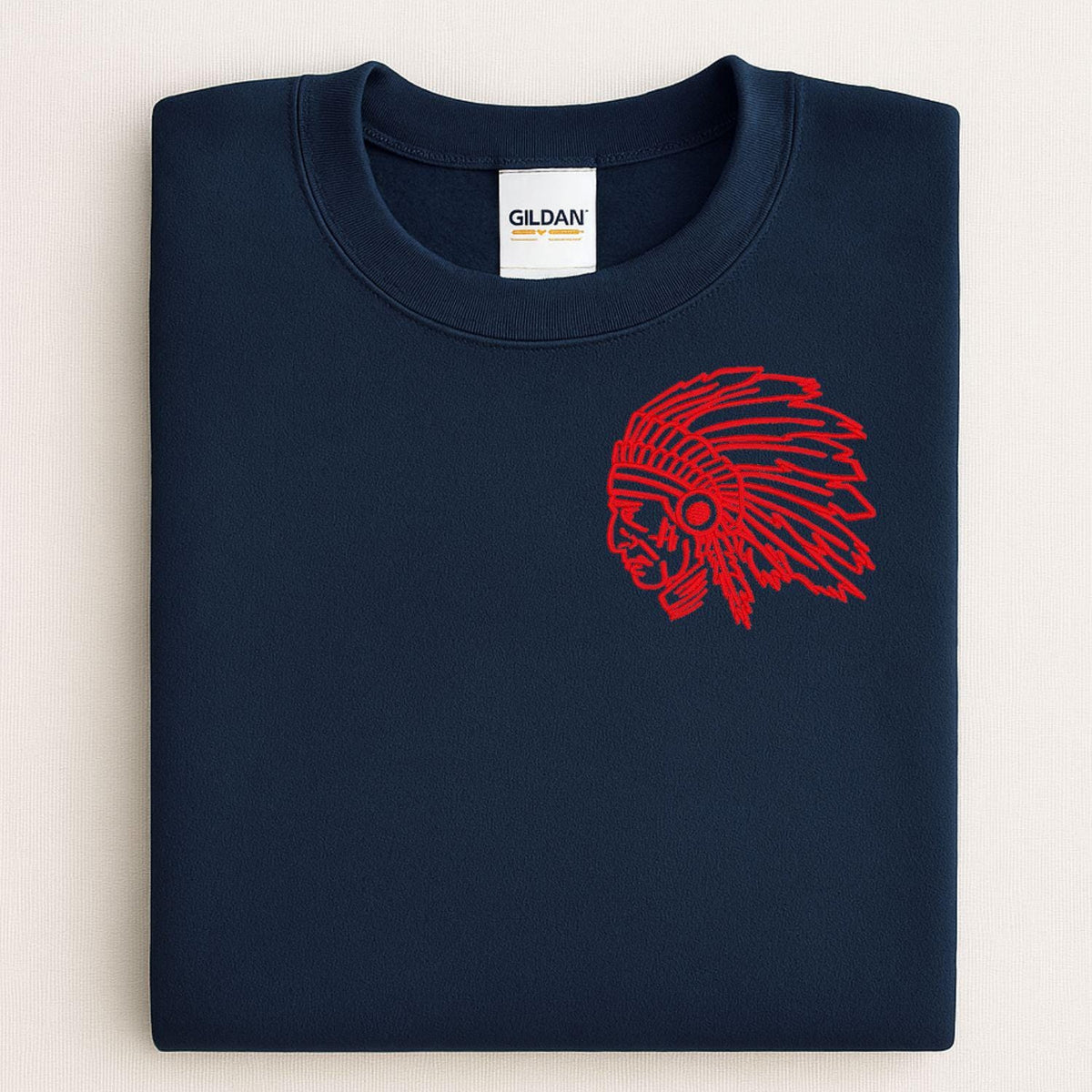 Navy sweatshirt with red left-chest headdress mascot embroidery folded flat