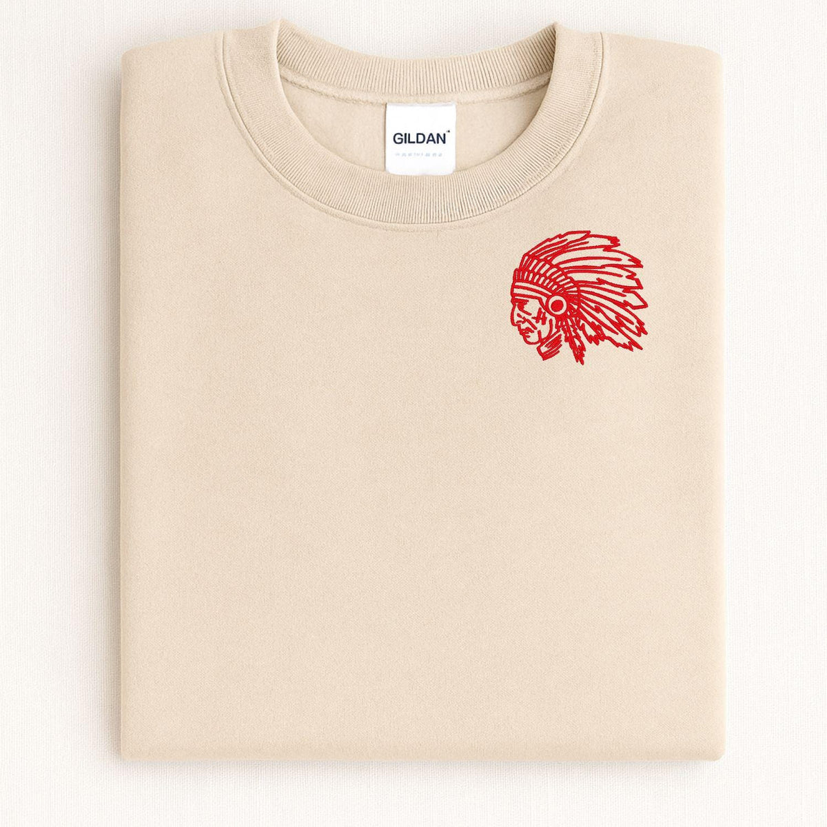 Sand headdress mascot embroidered crewneck folded on a light background