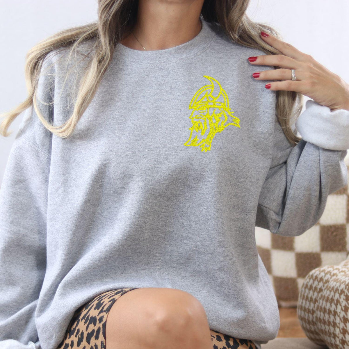 Sport gray left-chest Viking mascot sweatshirt modeled indoors