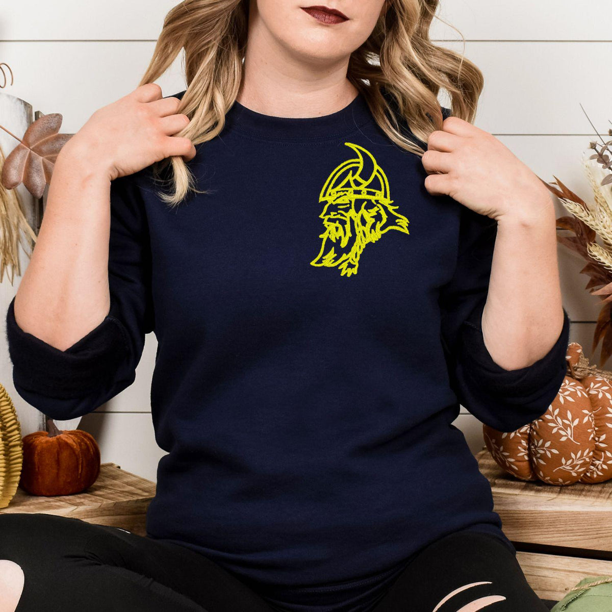 Navy sweatshirt with neon yellow left-chest Viking embroidery modeled indoors