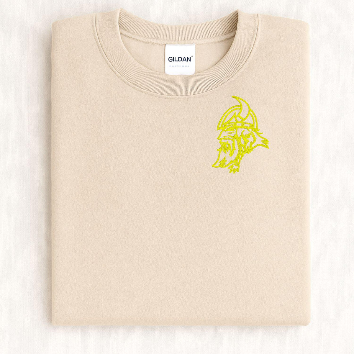 Sand Viking mascot embroidered crewneck folded on a light background