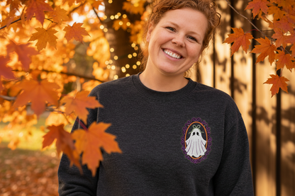 Close modeled view showing the scale and placement of framed ghost embroidery on a heathered-black crewneck.