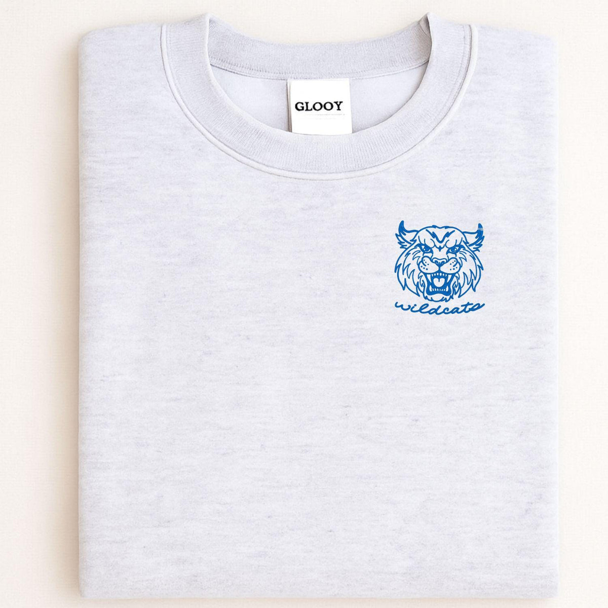 Sport gray sweatshirt with blue left-chest Wildcats mascot embroidery folded flat