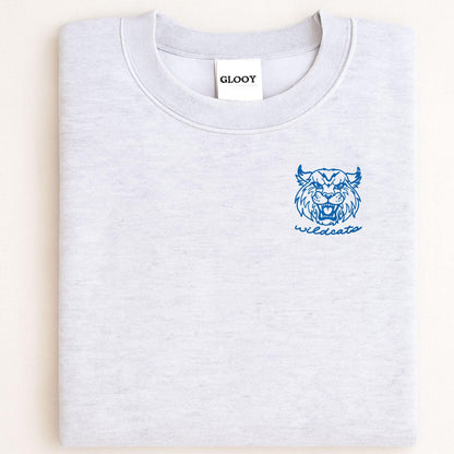 Sport gray sweatshirt with blue left-chest Wildcats mascot embroidery folded flat