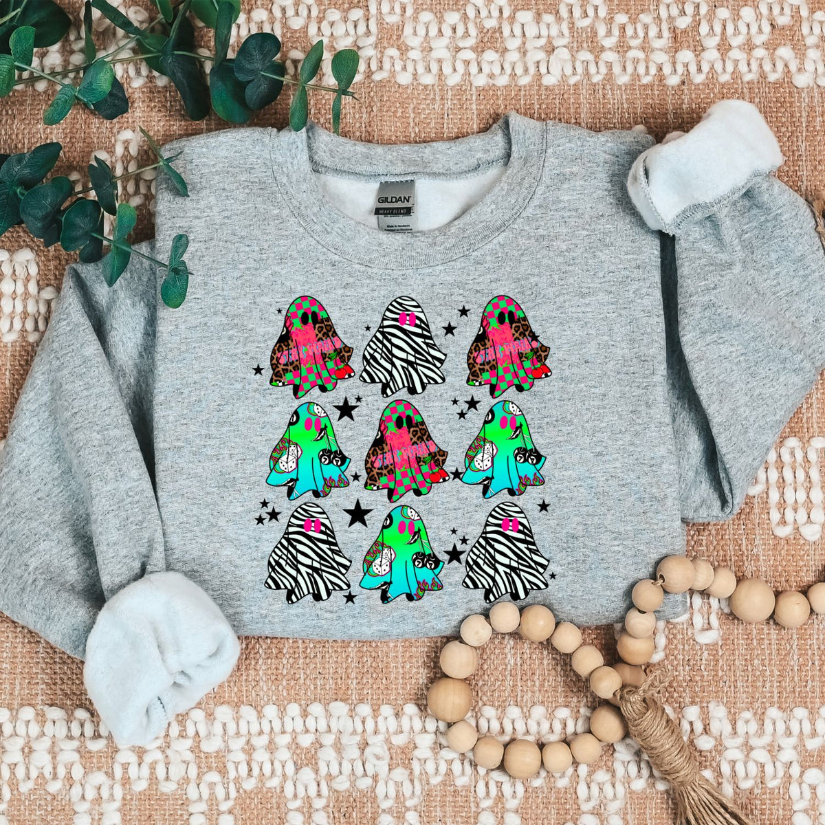 Retro Halloween sweatshirt featuring colorful patterned ghosts